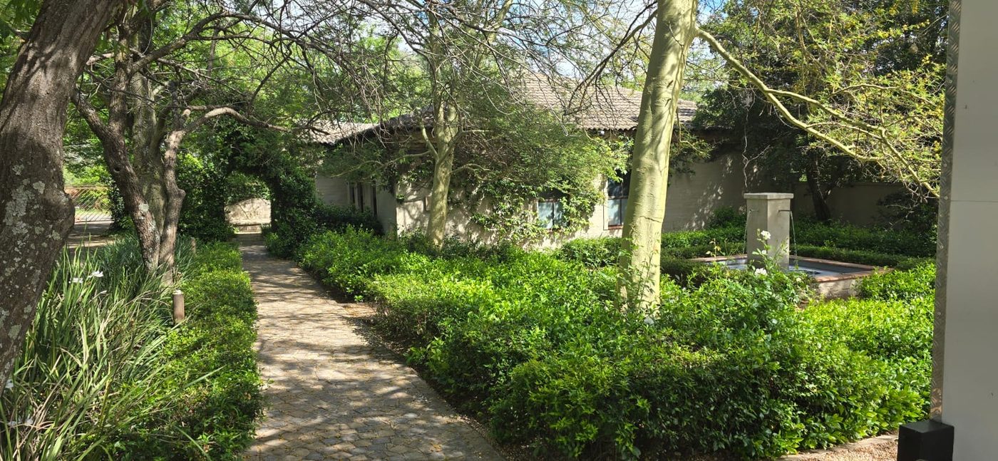 Garden path leading past the fountain to the house